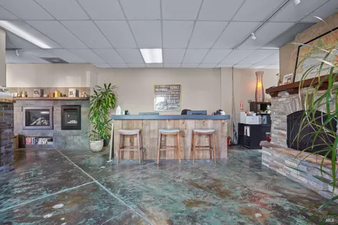 a kitchen with refrigerator and chairs