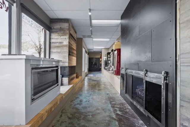 a view of a kitchen with a stove fridge and wooden floor