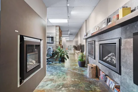 a hallway with furniture and a fireplace