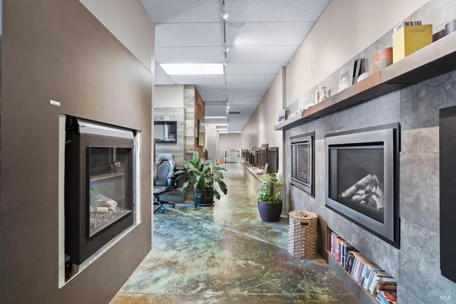 a hallway with furniture and a fireplace