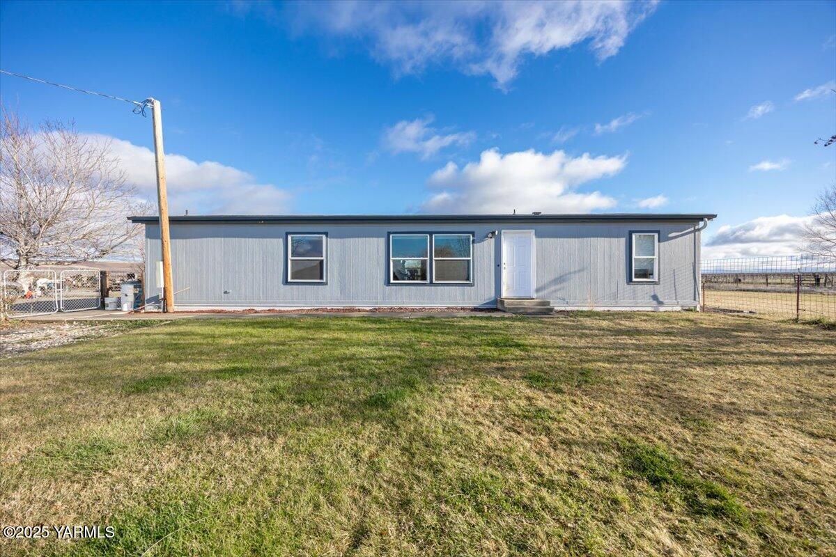 183 Puterbaugh Road Grandview, WA 98930 - Photo 1 of 36 a view of a house with a backyard