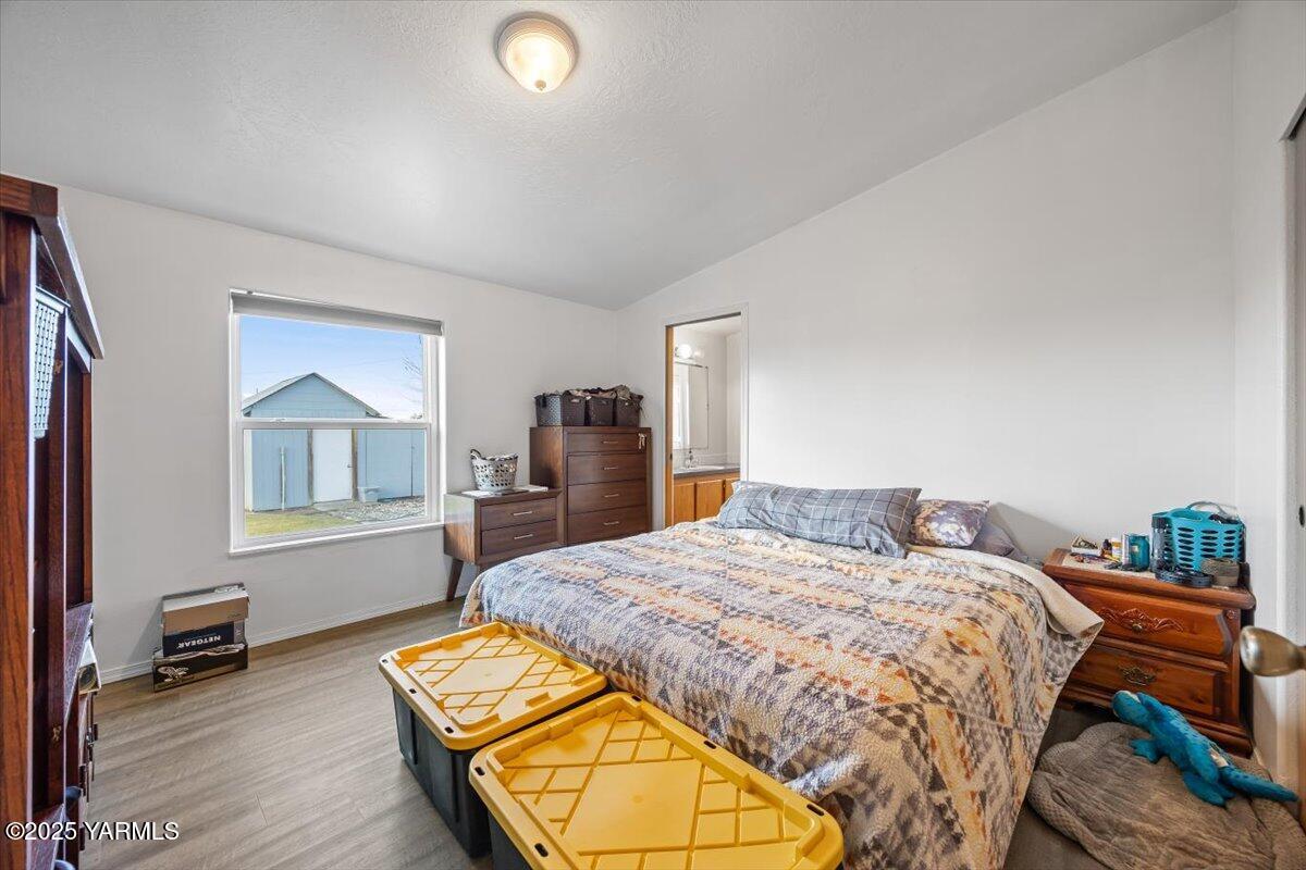 183 Puterbaugh Road Grandview, WA 98930 - Photo 13 of 36 a bed sitting in a bedroom next to a window