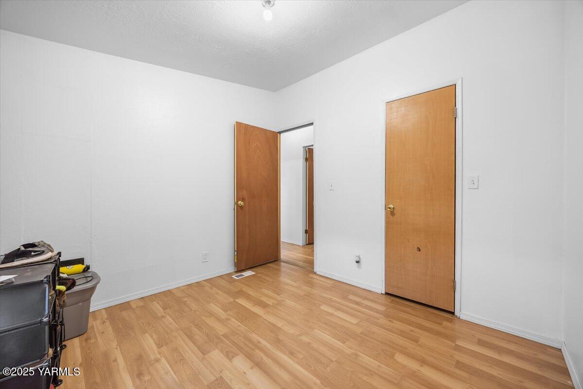 183 Puterbaugh Road Grandview, WA 98930 - Photo 17 of 36 a view of empty room with wooden floor