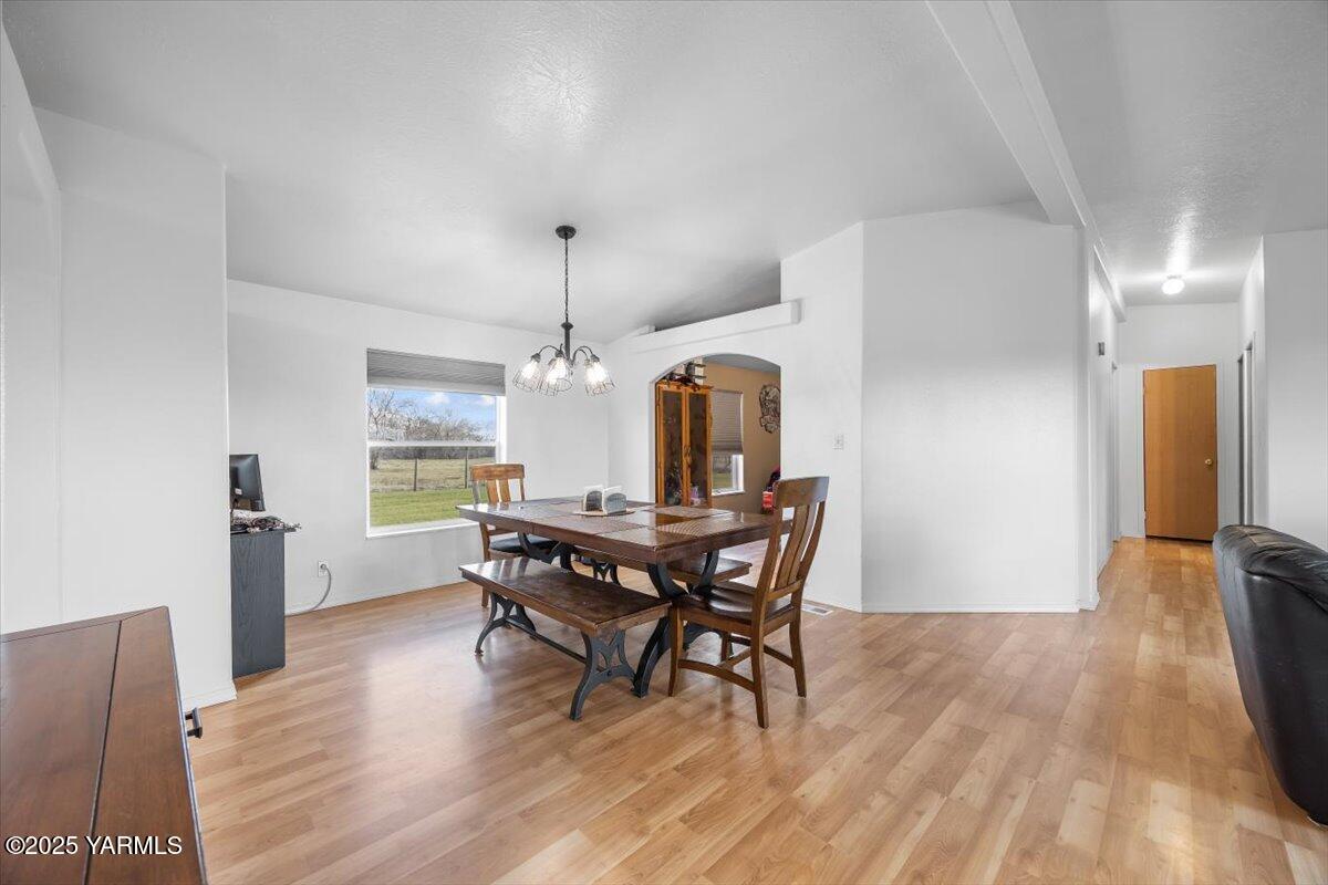 183 Puterbaugh Road Grandview, WA 98930 - Photo 7 of 36 a view of a dining room with furniture and wooden floor