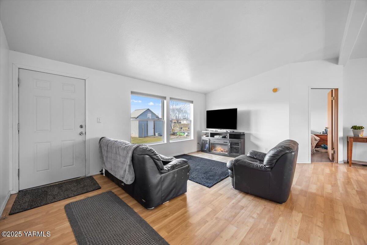 183 Puterbaugh Road Grandview, WA 98930 - Photo 10 of 36 a living room with furniture a flat screen tv and a fireplace