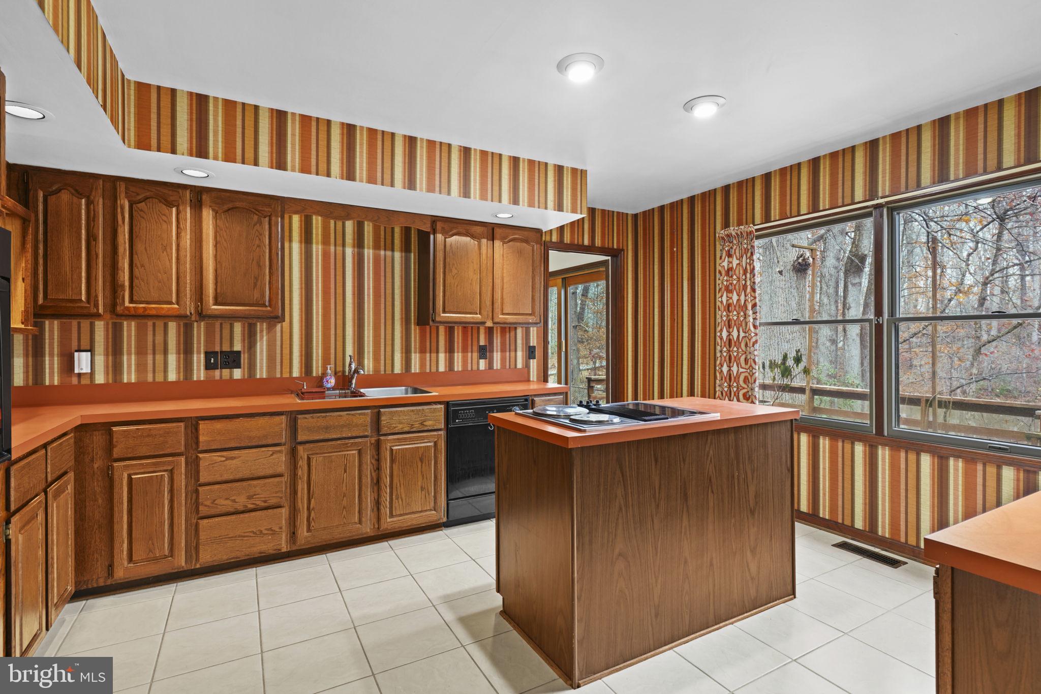 520 Chesapeake Beach Road Owings, MD 20736 - Photo 12 of 70 a kitchen with stainless steel appliances granite countertop a stove a sink and a refrigerator