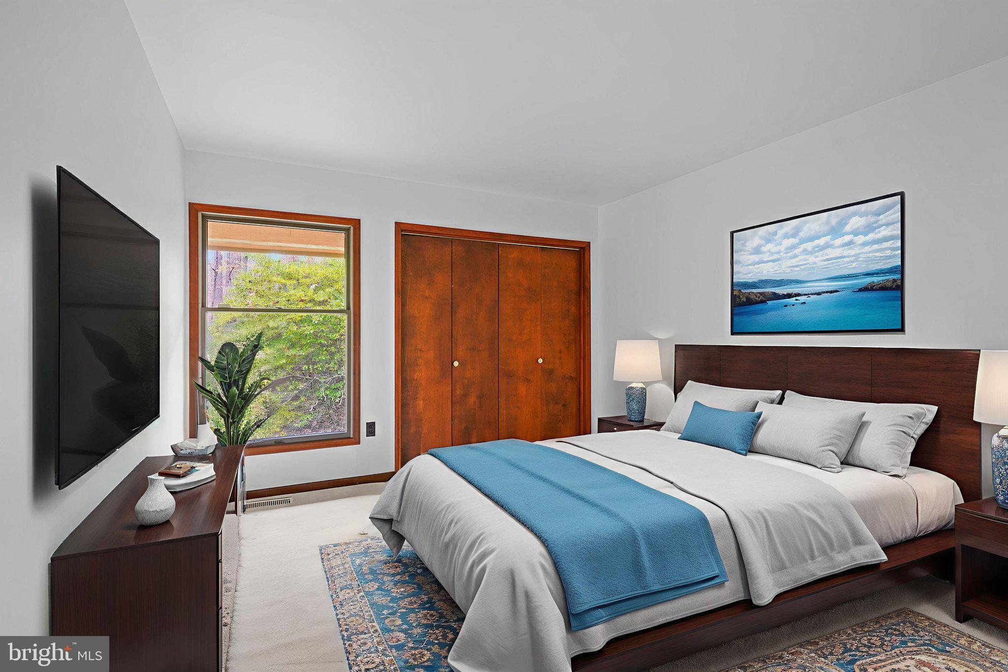 520 Chesapeake Beach Road Owings, MD 20736 - Photo 27 of 70 a bedroom with a large bed and a flat tv screen on dresser