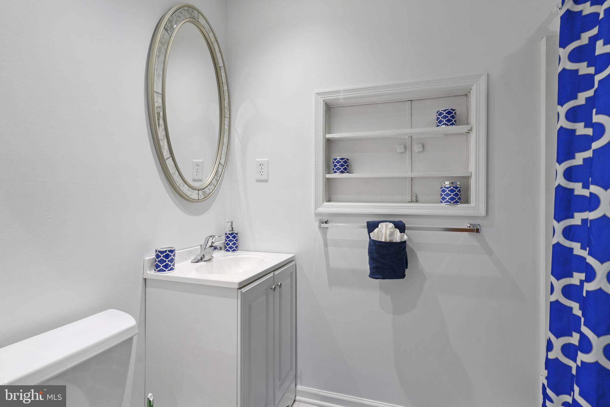520 Chesapeake Beach Road Owings, MD 20736 - Photo 29 of 70 a bathroom with a sink toilet and a mirror