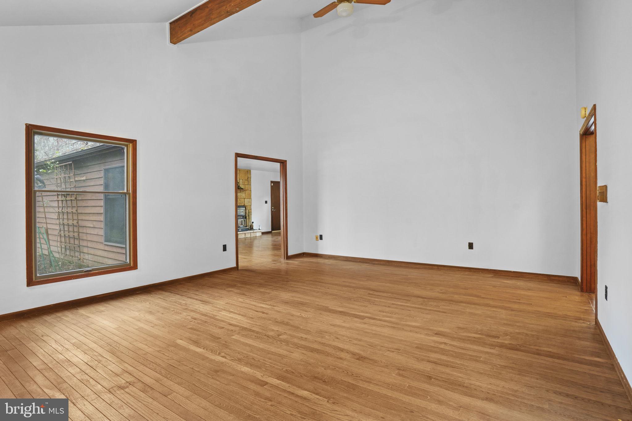 520 Chesapeake Beach Road Owings, MD 20736 - Photo 7 of 70 a view of an empty room with wooden floor and a window