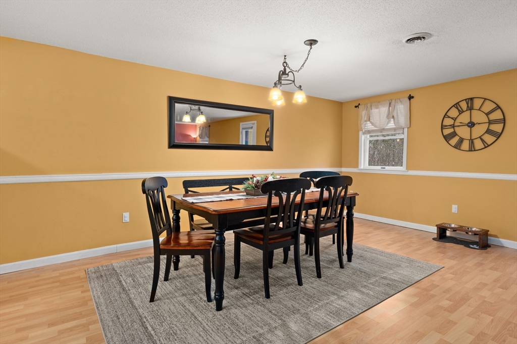 25 Shea Street, Unit 8 Dracut, MA 01826 - Photo 12 of 37 a view of a dining room with furniture and wooden floor