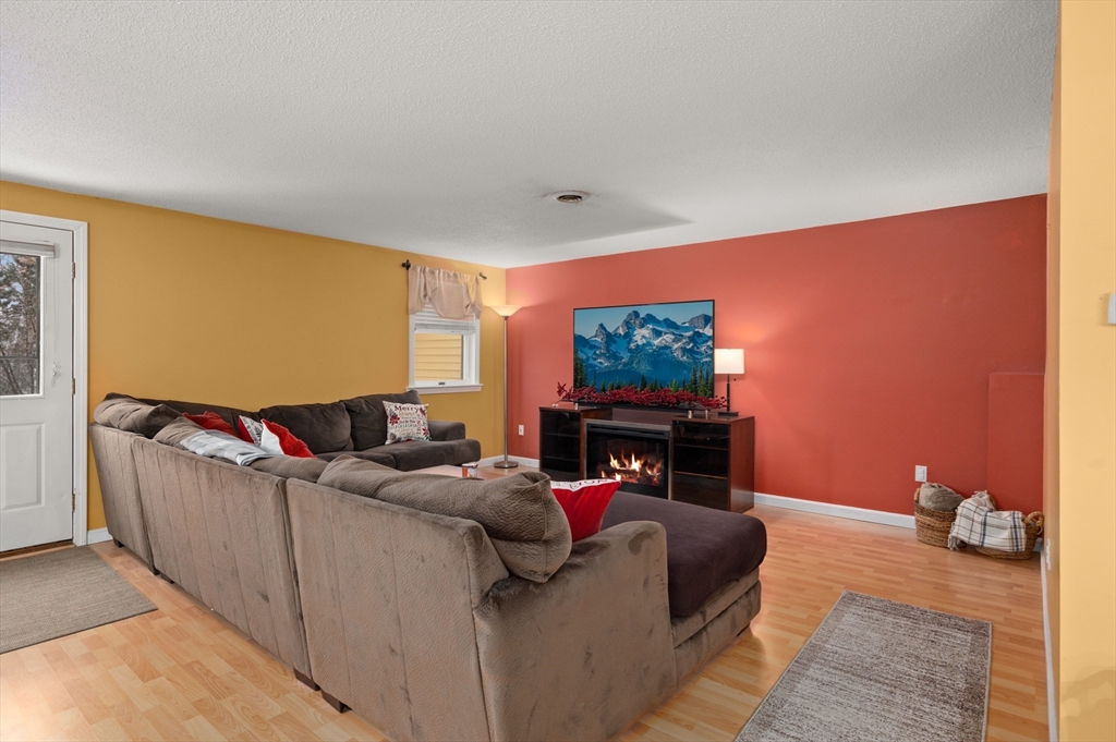 25 Shea Street, Unit 8 Dracut, MA 01826 - Photo 16 of 37 a living room with furniture and a flat screen tv