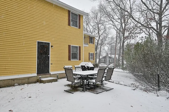 a view of a house with backyard and sitting area