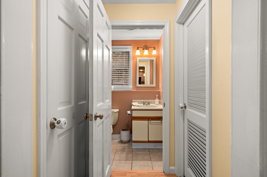 25 Shea Street, Unit 8 Dracut, MA 01826 - Photo 19 of 37 a bathroom with a toilet a sink and a mirror