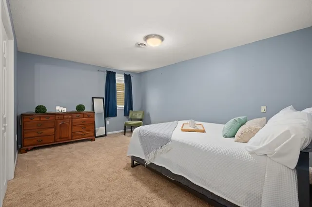 a bedroom with furniture and a window