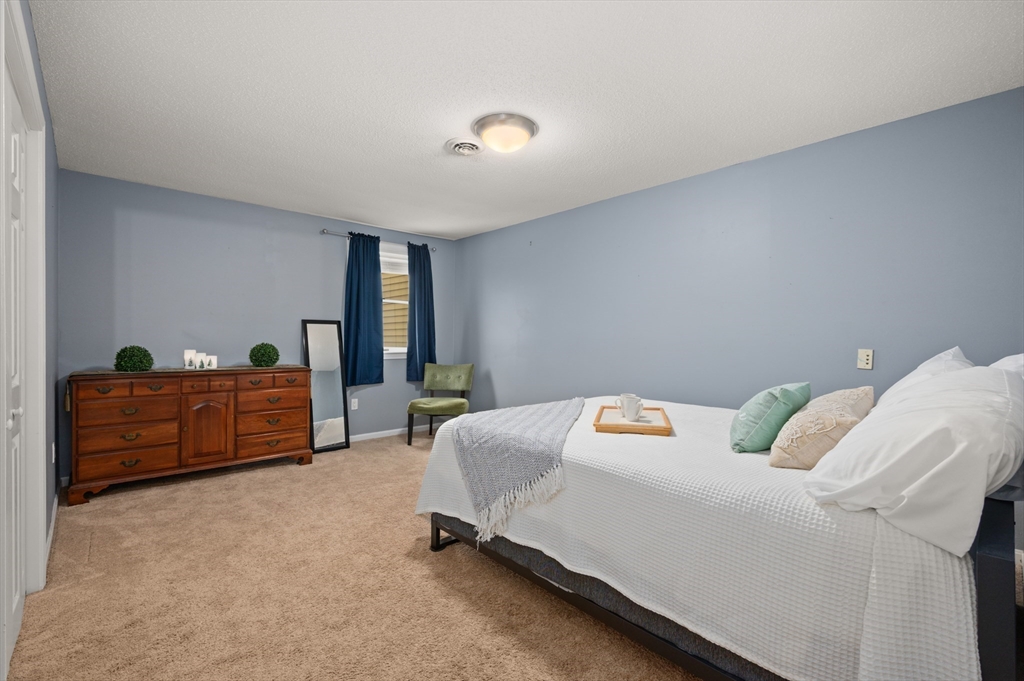25 Shea Street, Unit 8 Dracut, MA 01826 - Photo 26 of 37 a bedroom with furniture and a window