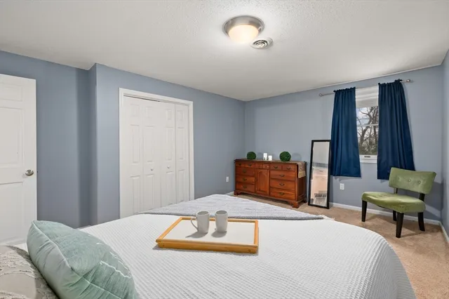 a bedroom with a bed and window