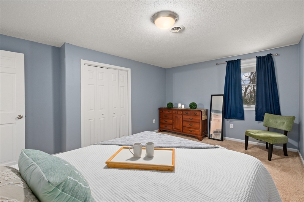 25 Shea Street, Unit 8 Dracut, MA 01826 - Photo 27 of 37 a bedroom with a bed and window