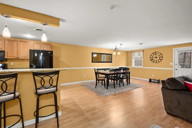 a view of a dining room with furniture and a chandelier