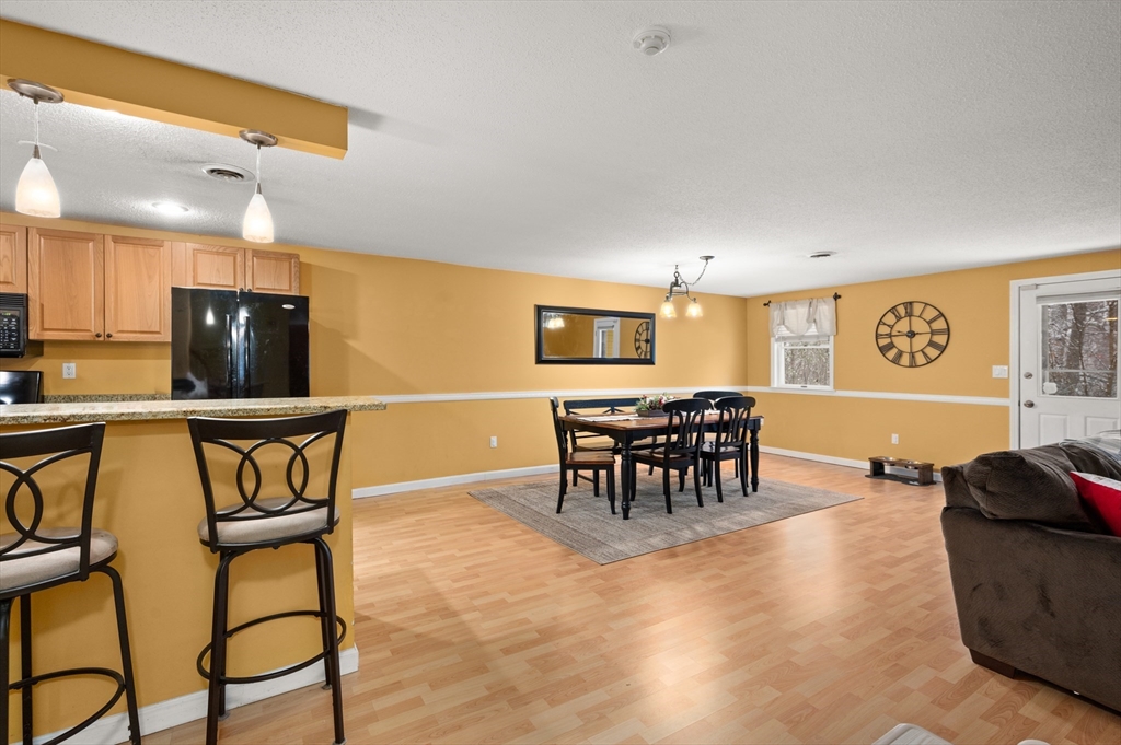 25 Shea Street, Unit 8 Dracut, MA 01826 - Photo 3 of 37 a view of a dining room with furniture and a chandelier