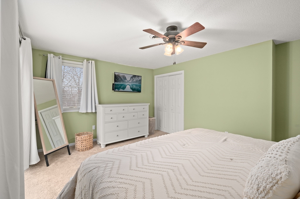25 Shea Street, Unit 8 Dracut, MA 01826 - Photo 31 of 37 a bedroom with a bed and a chandelier