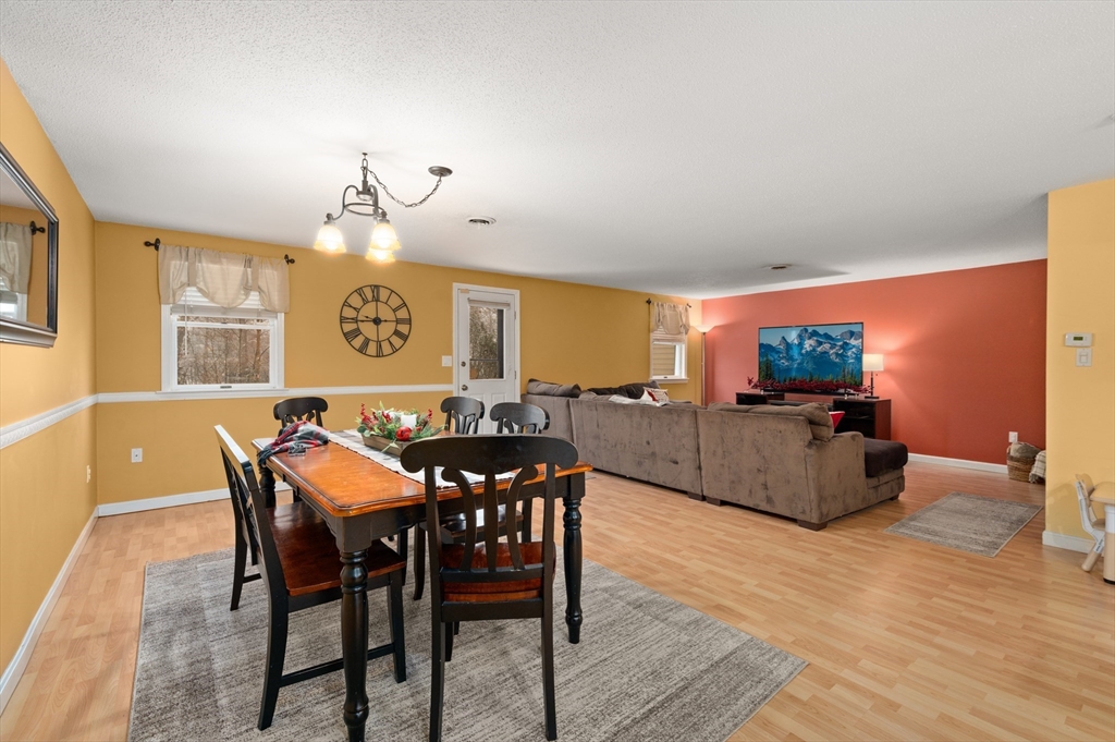 25 Shea Street, Unit 8 Dracut, MA 01826 - Photo 9 of 37 a view of a dining room with furniture and wooden floor