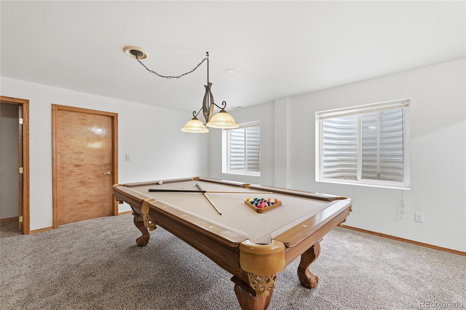 9288 Rockingham Drive Peyton, CO 80831 - Photo 28 of 49 a room with pool table and windows