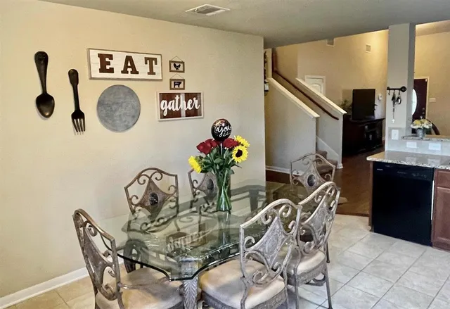 a view of a dining room with furniture and chandelier