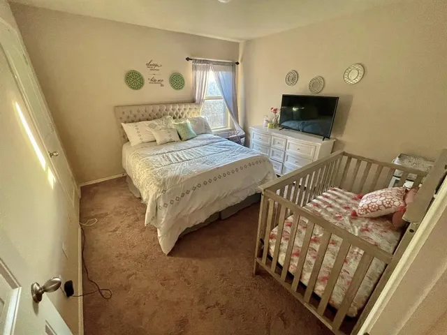 a bedroom with furniture and a flat screen tv