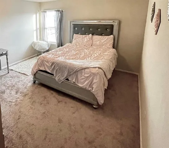 a bedroom with a bed and window
