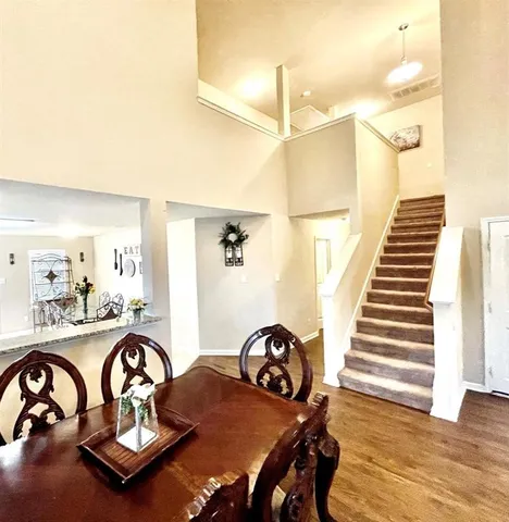 a dining room with furniture and wooden floor