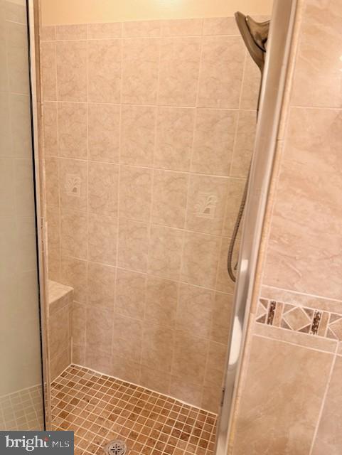 10714 Kings Riding Way, Unit 10121 Rockville, MD 20852 - Photo 15 of 24 Hallway bathroom features a walk-in shower
