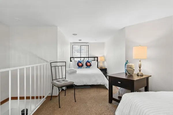 a bedroom with a bed and workspace