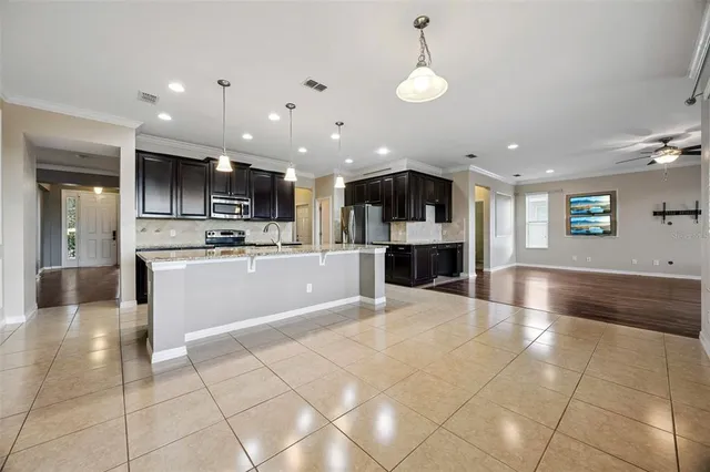 a view of kitchen with cabinets and refrigerator