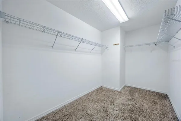 a spacious bathroom with a granite countertop sink mirror and shower