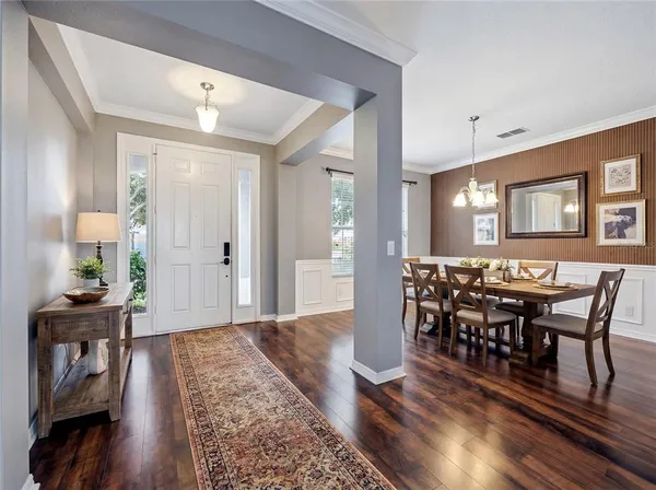 a view of a dining room with furniture and wooden floor