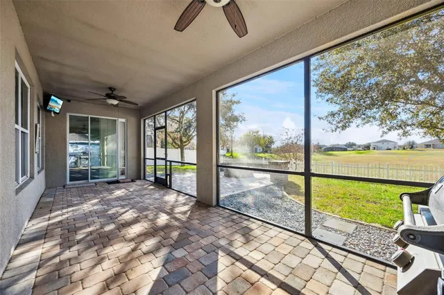 a view of yard with green space and trees