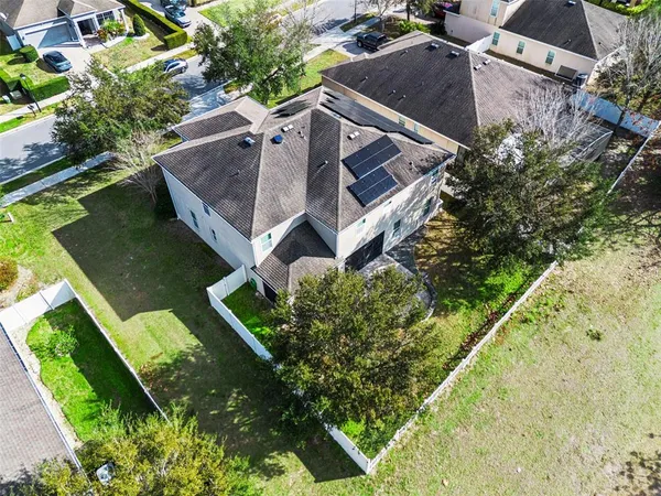 an aerial view of a house with outdoor space and lake view