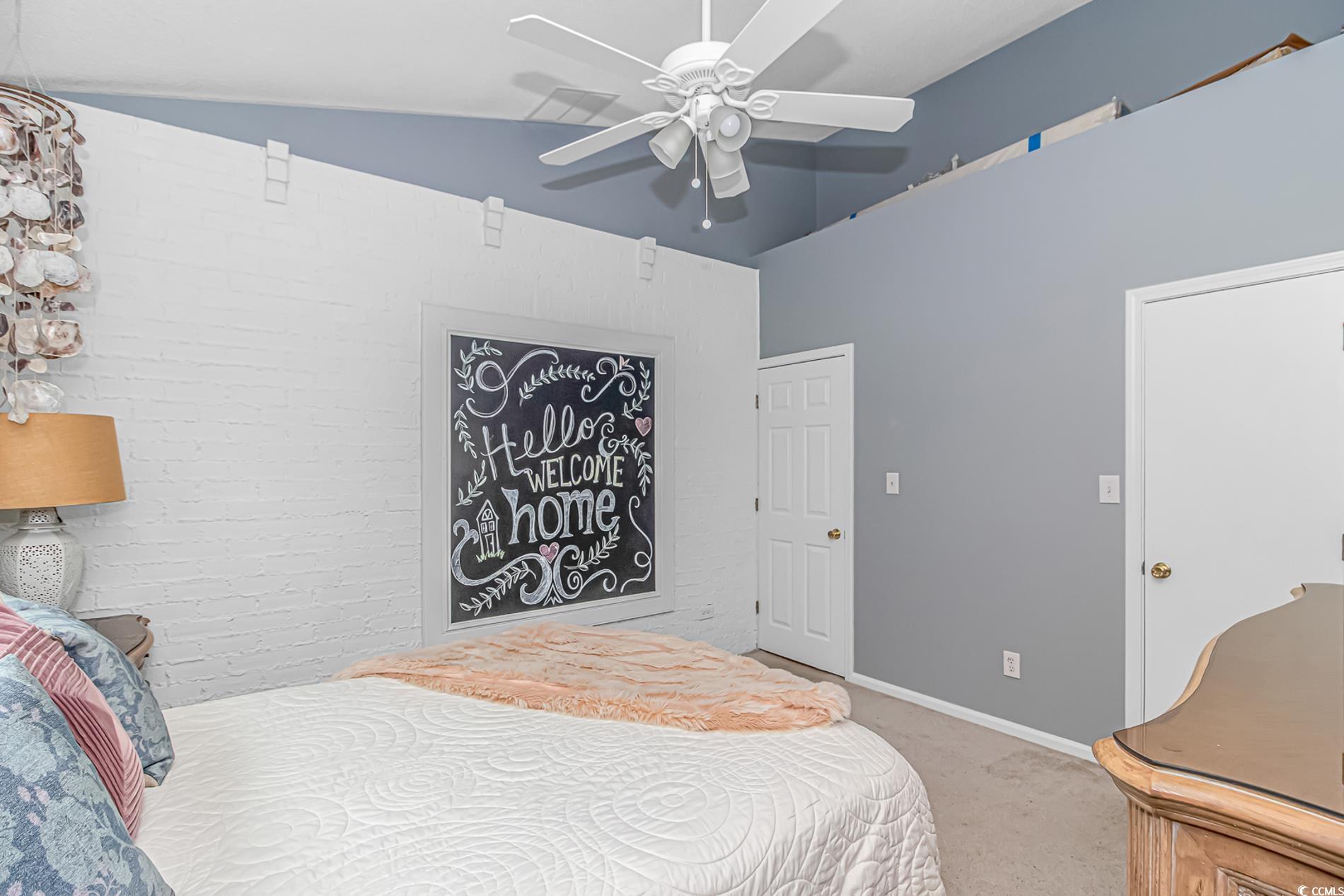 1474 Riceland Court Murrells Inlet, SC 29576 - Photo 19 of 30 Carpeted bedroom with lofted ceiling and ceiling f