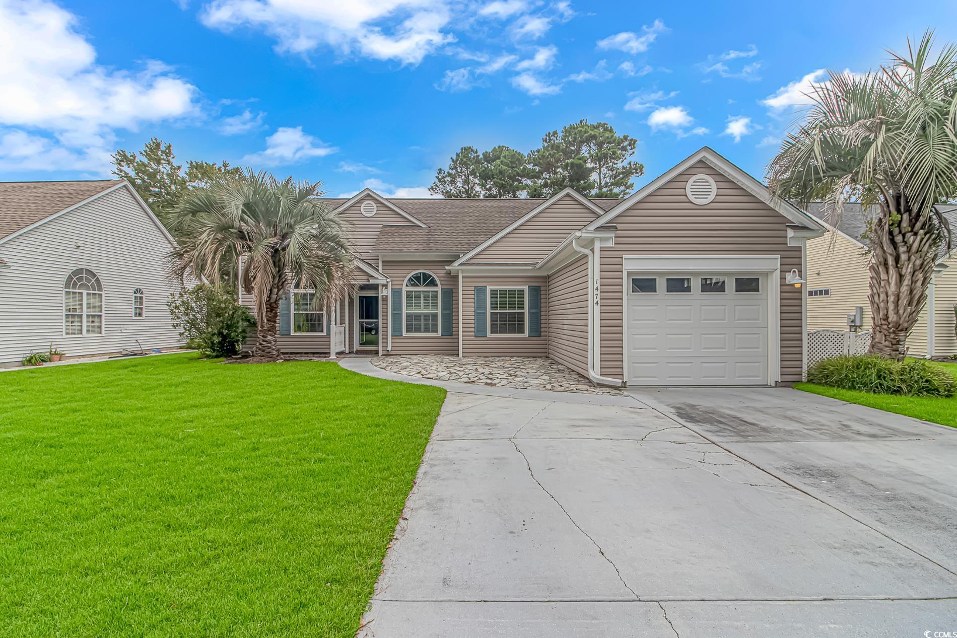 1474 Riceland Court Murrells Inlet, SC 29576 - Photo 2 of 30 Ranch-style house with a front yard and a garage