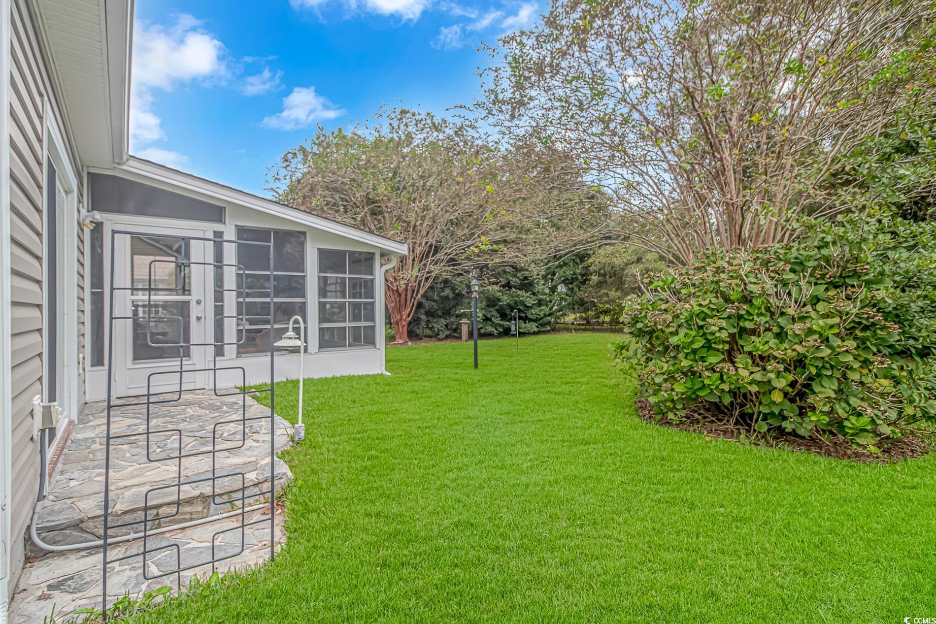 1474 Riceland Court Murrells Inlet, SC 29576 - Photo 24 of 30 View of yard featuring a sunroom and a patio