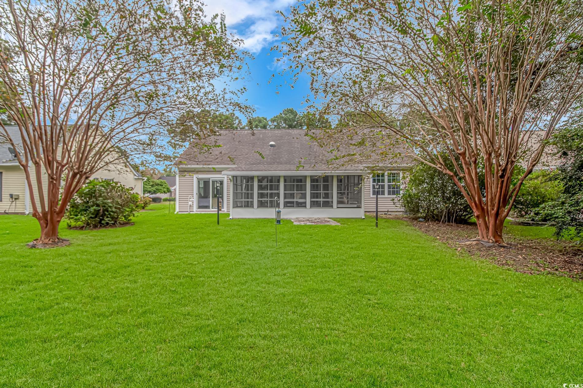 1474 Riceland Court Murrells Inlet, SC 29576 - Photo 26 of 30 Rear view of house with a lawn and a sunroom