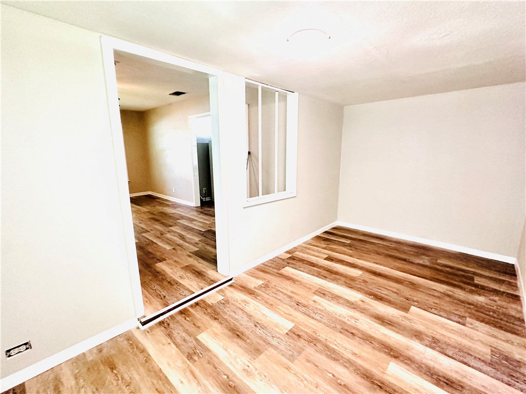 1202 Devon Drive Corpus Christi, TX 78404 - Photo 11 of 19 a view of a bedroom with wooden floor