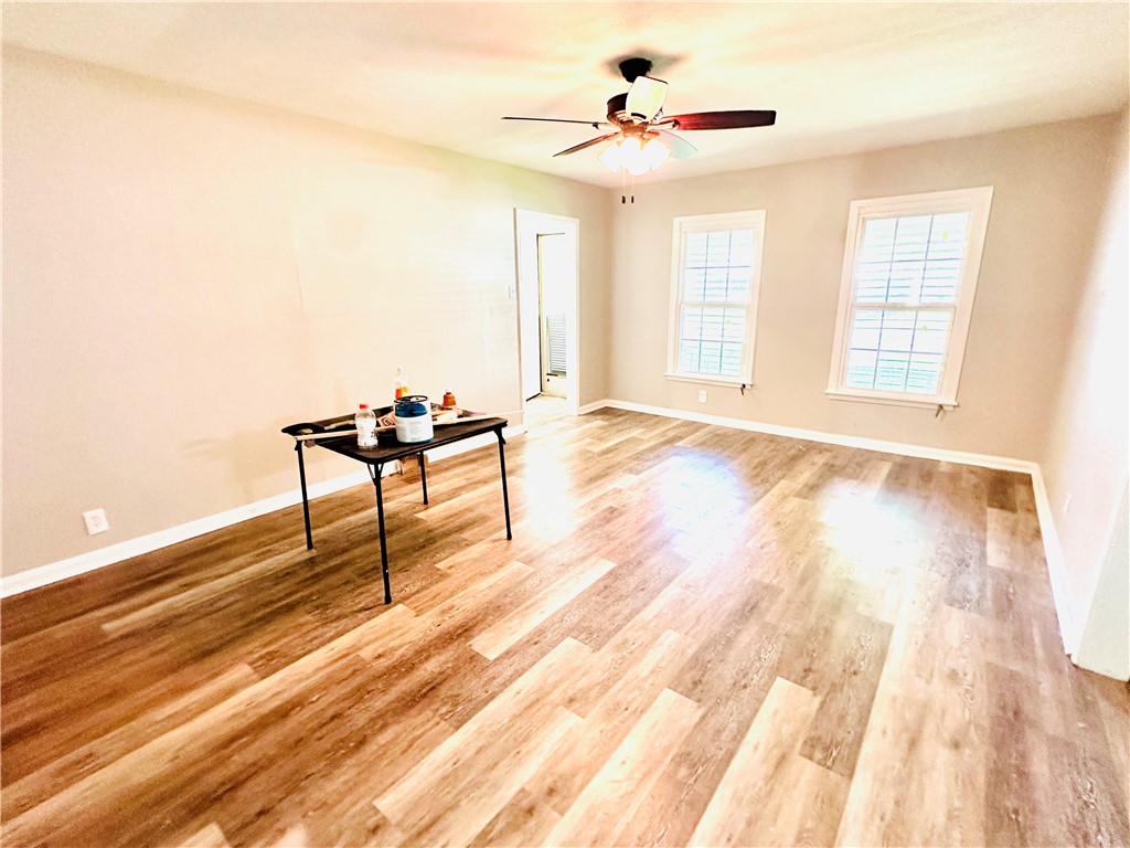 1202 Devon Drive Corpus Christi, TX 78404 - Photo 12 of 19 a view of an empty room with wooden floor and a window