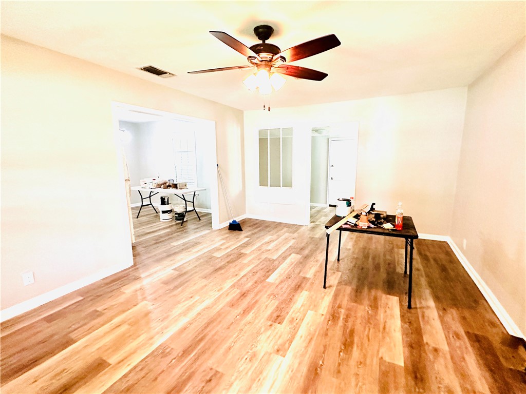 1202 Devon Drive Corpus Christi, TX 78404 - Photo 14 of 19 a view of a room with wooden floor and ceiling fan