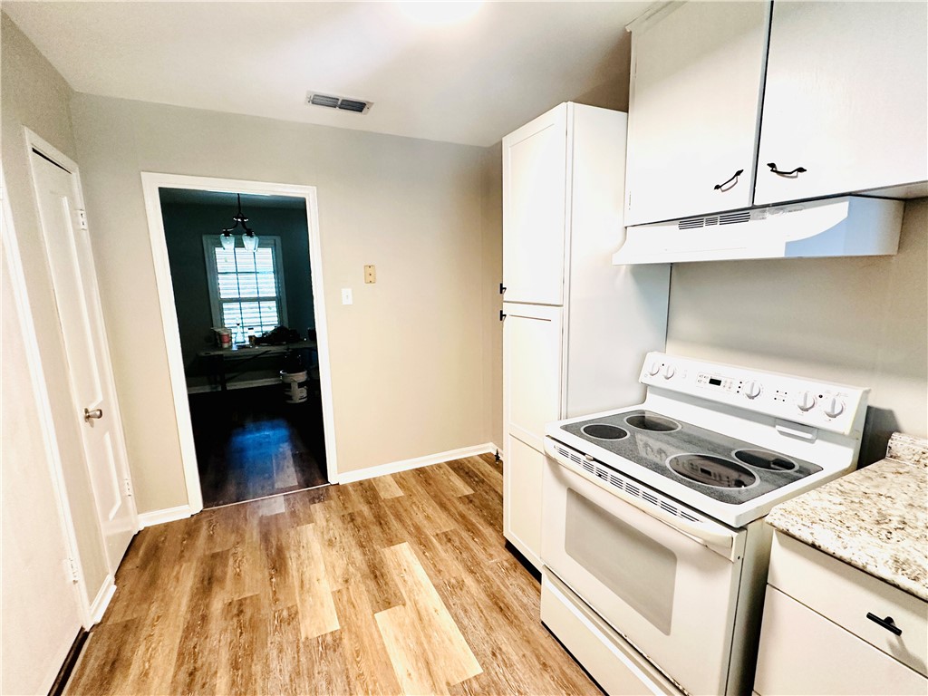 1202 Devon Drive Corpus Christi, TX 78404 - Photo 4 of 19 a kitchen with a stove and a refrigerator