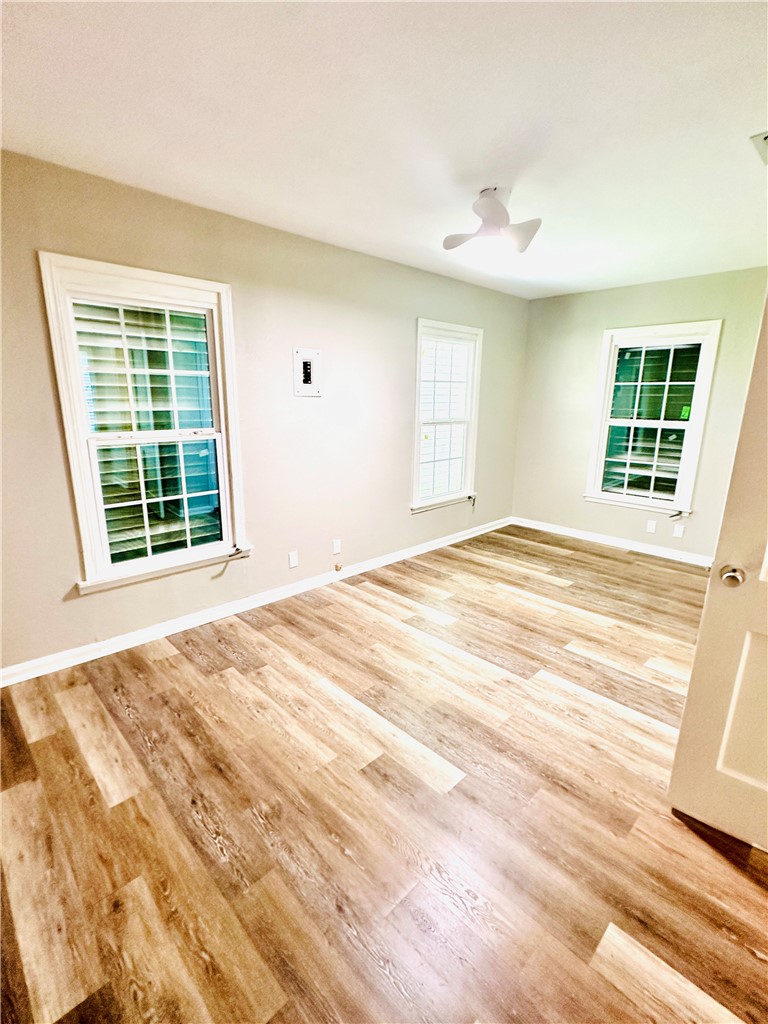 1202 Devon Drive Corpus Christi, TX 78404 - Photo 5 of 19 a view of an empty room with wooden floor and a window