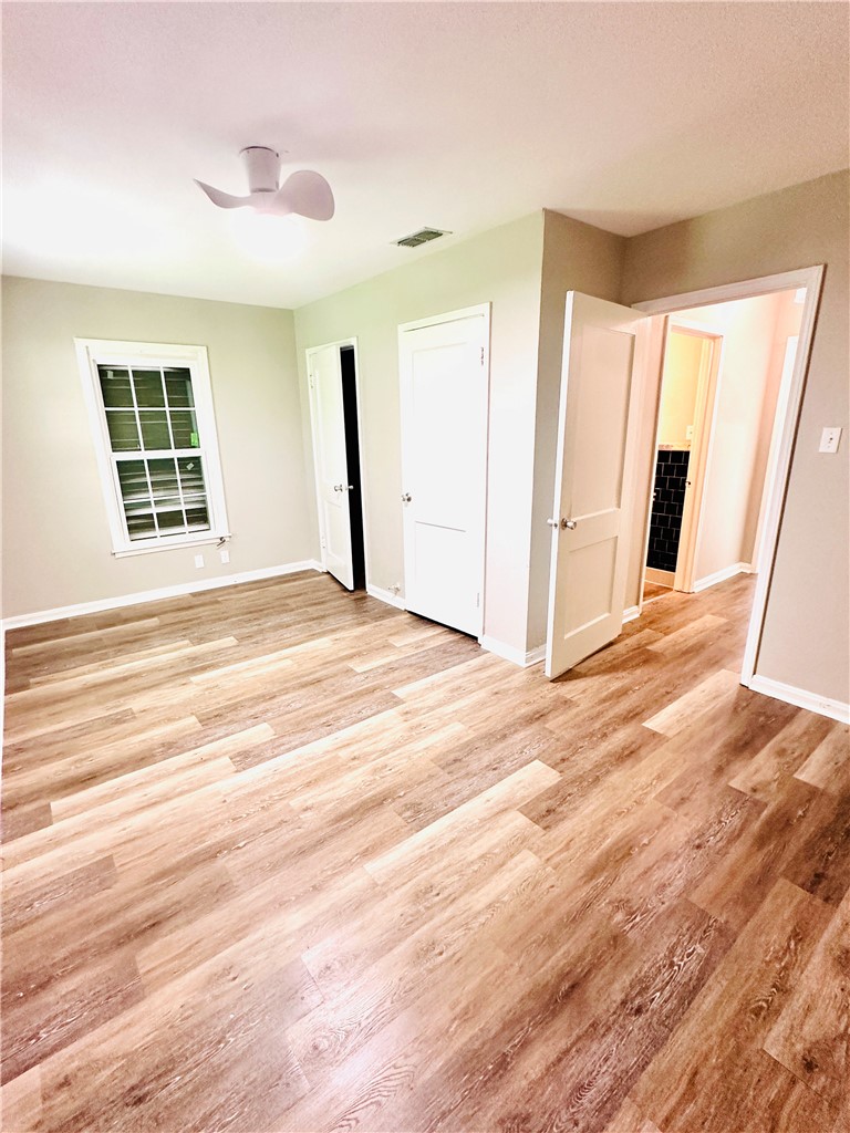 1202 Devon Drive Corpus Christi, TX 78404 - Photo 6 of 19 a view of an empty room with wooden floor and a window