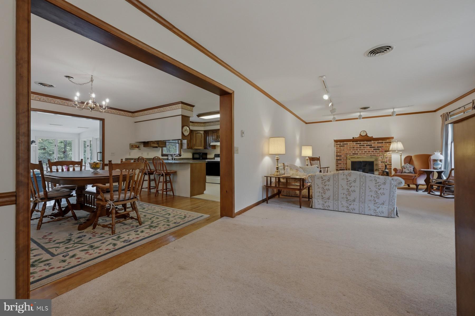 9829 Bantry Road Easton, MD 21601 - Photo 65 of 65 a living room with furniture and a dining table with kitchen view