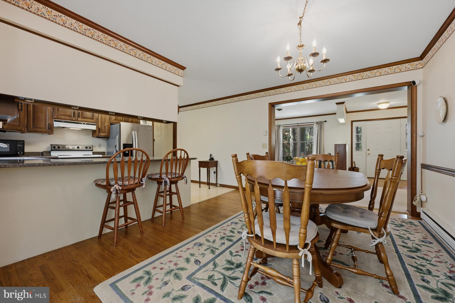 9829 Bantry Road Easton, MD 21601 - Photo 22 of 65 a view of a dining room with furniture and wooden floor
