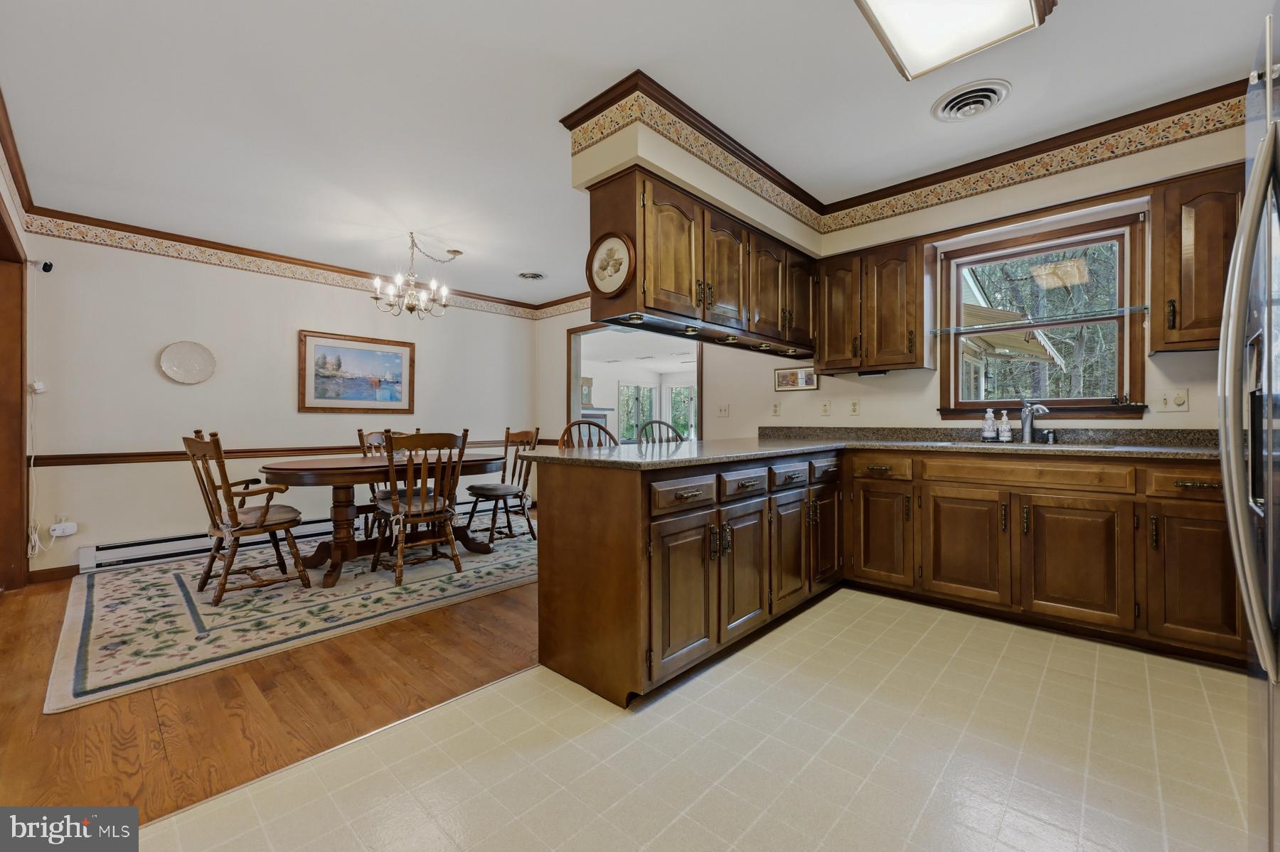 9829 Bantry Road Easton, MD 21601 - Photo 23 of 65 a kitchen with stainless steel appliances granite countertop a stove a sink dishwasher and cabinets